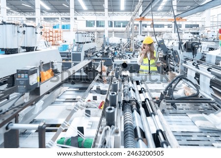 Through continuous learning and adaptation, the female engineer and her colleagues stay ahead of the curve in integrating emerging technologies into the industrial factory's machinery systems.