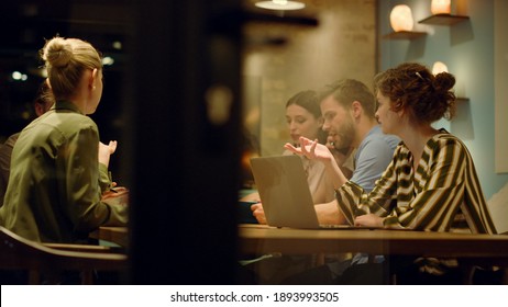 Through glass wall view smart business people working in conference room. Creative team discussing business in glass wall office. Successful colleagues giving high five in boardroom of startup office. - Shutterstock ID 1893993505