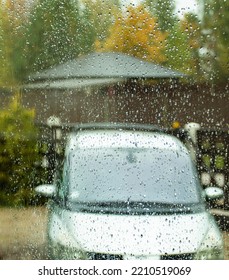 Through The Window Splashed With Autumn Rain One Can See A Car Standing In The Yard And Yellowed Trees