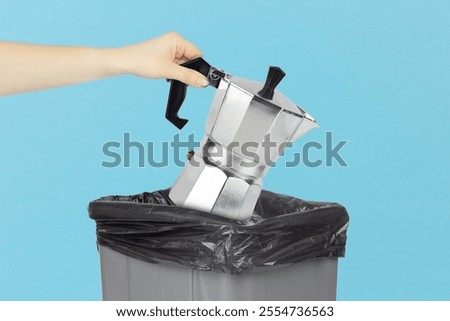 throw old coffee maker into the trash bin, hold the coffee maker in your hand in front of the trash can