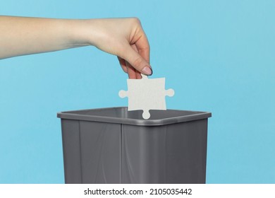 Throw Puzzle Piece Into Trash Can, Puzzle In Hand In Front Of Trash Can, Bad Idea Concept