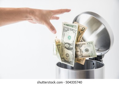 throwing away dollar in trashcan