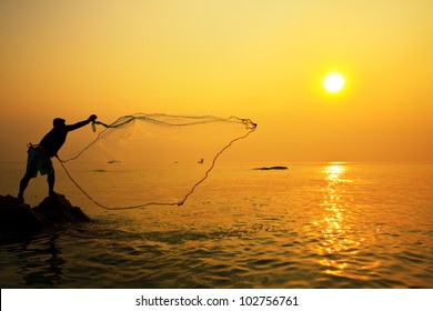 Throwing Fishing Net During Sunrise