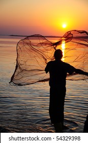 Throwing Fishing Net During Sunset