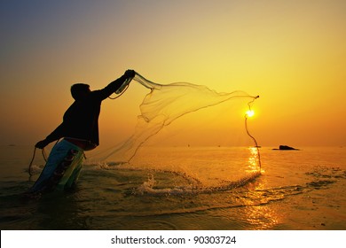 Throwing Fishing Net During Sunset