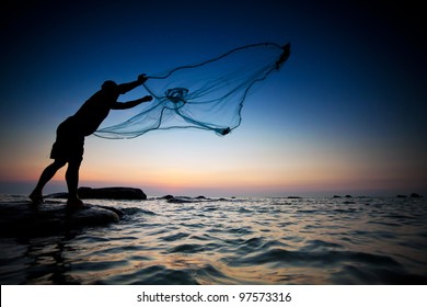 Throwing Fishing Net During Sunset , Thai