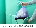 Throwing garbage into the garbage chute, a man