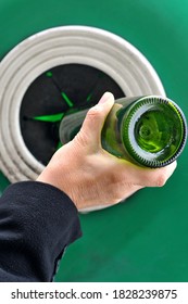 Throwing A Glass Bottle In A Recycling Bin Close Up