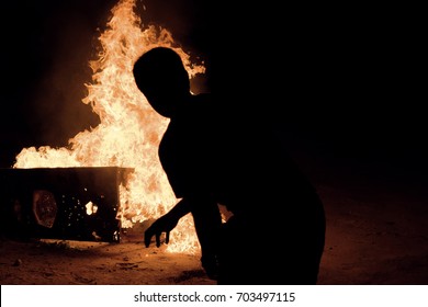 Throwing Molotov Cocktail onto Metal at Night - Shutterstock ID 703497115