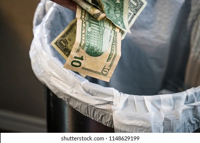 throwing-money-away-into-trash-260nw-1148629199.jpg