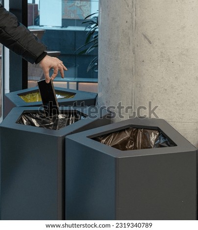 Throwing Out Smartphone, Put Electronic Device Into Trash Can, Throwed Away Smartphone, Dangerous Garbage Concept, Blurred Background