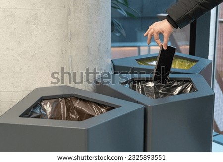 Throwing Out Smartphone, Put Electronic Device Into Trash Can, Throwed Away Smartphone, Dangerous Garbage Concept, Blurred Background