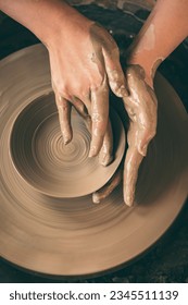 Throwing pottery on the wheel