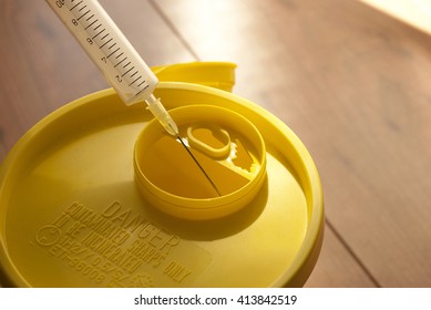 Throwing The Syringe In A Sharps Disposal Bin.