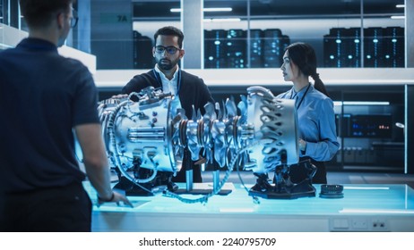 Thrust Engine Engineer, Project Manager and Machinery Operator Work on a Futuristic Turbine Motor, Standing with Tablet Computer in Scientific Technology Lab. Professional Team Developing a Prototype.