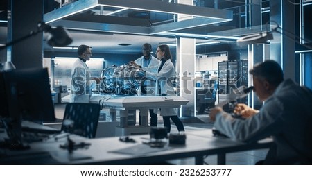 Thrust Engine Engineer, Project Manager and Machinery Operator Work on a Futuristic Turbine Motor, Standing with Tablet Computer in Scientific Technology Lab. Professional Collegue Using Microscope.