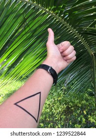 Thumb Up Hand With Triangular Airbrush Tattoo On Palm Background
