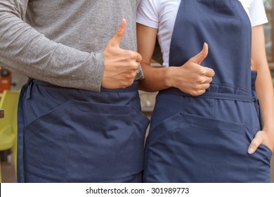 Thumbing Up. Portrait Of Mail And Female Cafeteria Workers Standing With Thumbs Up 