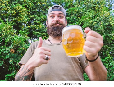 Thumbs Up To The Best Beer. Man Drinker Holding Beer Mug. Bearded Man Enjoy Drinking Beer On Nature. Brutal Hipster With Long Beard Having Craft Beer.