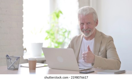 Thumbs Up By Old Man Using Laptop In Office