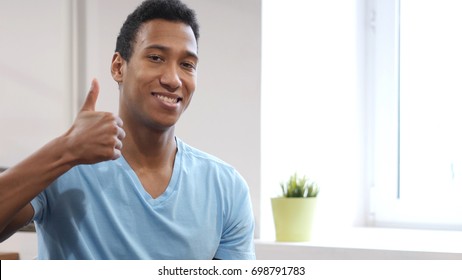 Thumbs Up by Young Black Man - Shutterstock ID 698791783