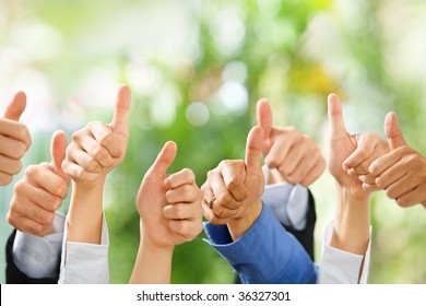 Thumbs Up From Diverse Group Of People On Green Background