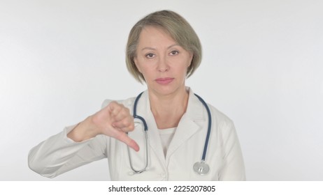 Thumbs Down By Old Female Doctor On White Background