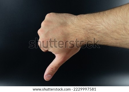 Thumbs down sign isolated on background. Unlike, bad, unapproved or failed gesture.