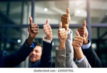 Thumbs up with hands of a business team or group giving their approval, saying thank you or giving motivation together in their office at work. Corporate professionals supporting with trust - Shutterstock ID 2190357961