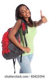 Thumbs up happy success for pretty young African American teenager school girl, with long black hair wearing green t-shirt and red school backpack with beautiful smile.