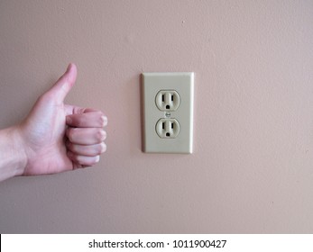 Thumbs Up Next To An American Wall Outlet