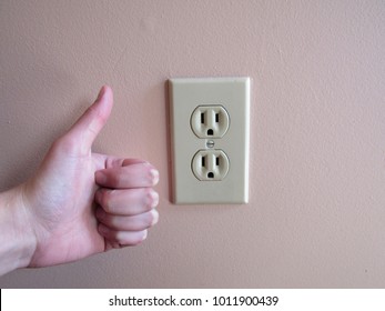 Thumbs Up Next To An American Wall Outlet