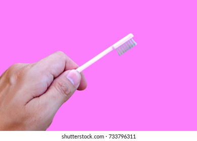 Thumbs Up with Pink Toothbrush on pink background - Shutterstock ID 733796311