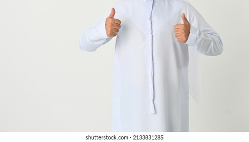 Thumbs Up UAE Emirati Arab Man Standing Wearing Traditional Emarati Dish Dash Dress On Studio White Background