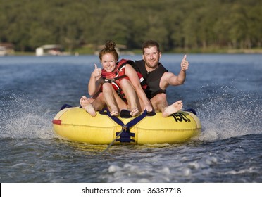 Thumbs Up While Tubing On A Lake