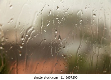 Thunderclouds. dramatic scene. The sun is absorbed by the clouds. The smoke in the sky and the strong wind. Storm. Glass window with raindrops.