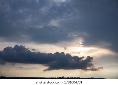 Thunderclouds with sunbeam . Black clouds over the city 