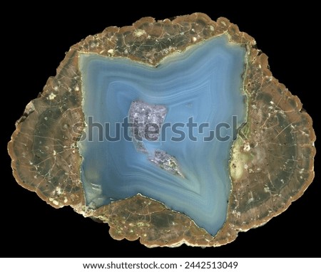 A thunderegg agate geode specimen from the location known as Desolation Canyon, Oregon. A beautiful blue agate surrounded by a rhyolite matrix. This is a specimen that has been cut in half.