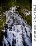 Thundering Brook Falls with frozen ice in snow in Killington, Vermont, USA