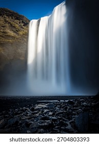 Skógafoss thunders down with unstoppable force, often crowned by a rainbow—a true Icelandic spectacle