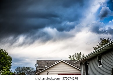 Thunderstorm clouds over suburban houses