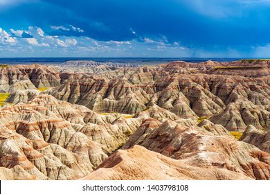 A thunderstorm inside Badlands national park with the rock formations illuminated by sunlight, Rapid City, South Dakota, USA.