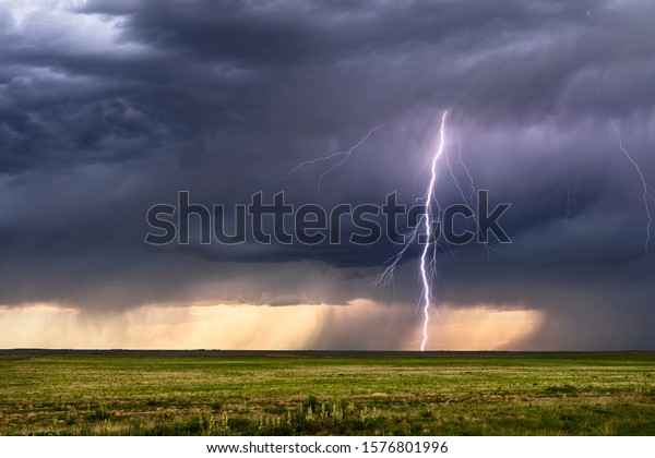 Thunderstorm\
lightning bolt strike with storm\
clouds