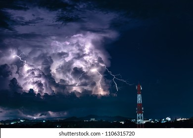 Thunderstorm With Lightning Over The Cell Phone Antenna Tower At Night