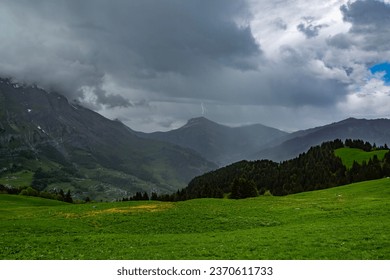 Thunderstorm on the Aravis range, lightning strikes the summit of Croisse Baulet (2236m)