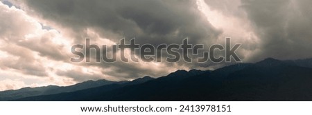 Thunderstorm over highland valley in Caucasus mountains. Dark massive clouds and rainfall approaching to Bermamyt plateau on a summer day. Dali -Yunnan, China