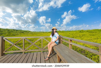 Thung Prong Thong, Rayong Province,Asian women on wooden bridge at Mangrove forest ecotourism Thung Prong Thong, Rayong Province, Thailand