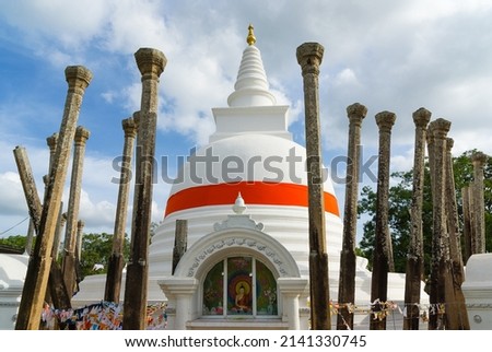 Thuparamaya stupa with remains of stone collumns, Sri Lanka (Translation of sign: Worshiping Buddha)