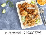 Thyme Baked Chicken Drumsticks with Condiment Top Down Food Photo