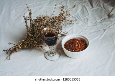 Thyme Bouquet, Shot Glass Of Chokeberry Tree Liqueur And Rooibos (redbush) Tea In A Bowl On A Flax Linen Cloth Table Background 